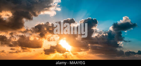 sunset sky - scenic sky and cloudscape - sunshine through clouds Stock Photo
