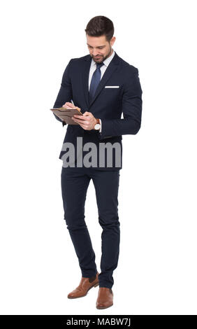 Young caucasian businessman writing on clipboard, isolated on white Stock Photo
