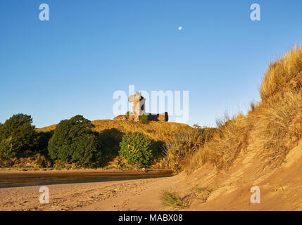 The early morning Golden light sets off the red sandstone castle walls of the Red Castle near Lunan Bay, Inverkeilor, Scotland. Stock Photo