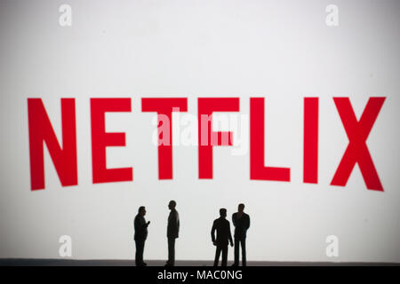 Netflix logo with models of people in foreground Stock Photo