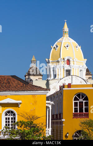 Rising behind mustard colored walls of Cartegena's Museo Naval Del Caribe is the lemon restored dome of the San Pedro Claver Church & Convent. Stock Photo