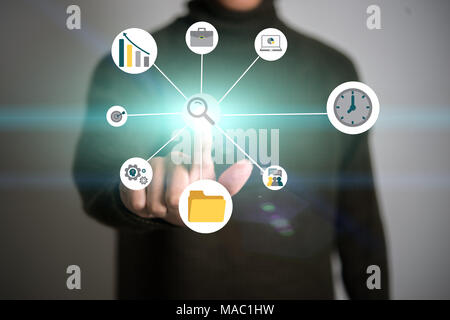 Businessman touching multimedia network with business flat icon against his finger. Stock Photo