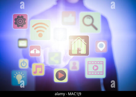 Close up of young man touching icon of media screen. Multimedia and technology concept. Stock Photo
