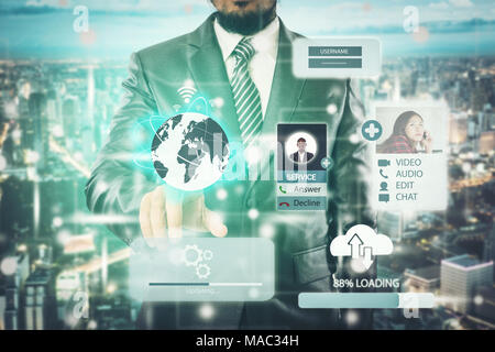 Double exposure of businessman press on global  button sign to start projects and abstract city at night. Stock Photo