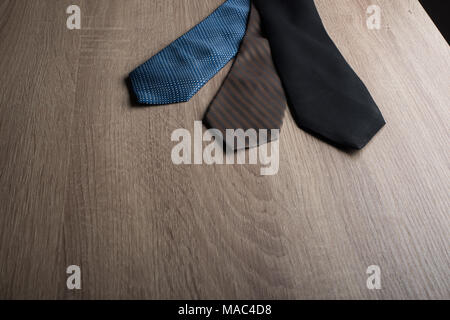 Silk neck ties on wooden background. Stock Photo