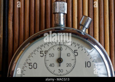 Vintage antiques Stopwatch, retro on wooden background, value measure time old clock arrow minute second accuracy timer record Stock Photo