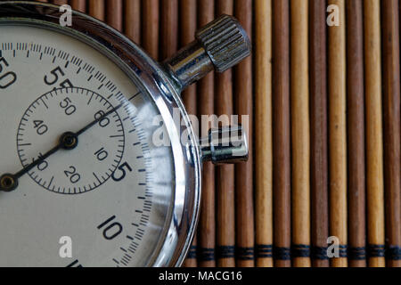 Vintage antiques Stopwatch, retro on wooden background, value measure time old clock arrow minute second accuracy timer record Stock Photo