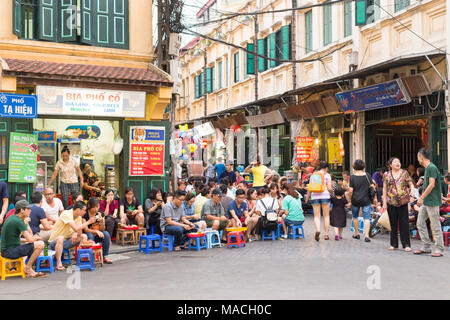 Tourists and locals drinking beer on the street in the Old Quarter in Hanoi, Vietnam Stock Photo