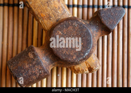 Vintage small hammer head on wooden table background Stock Photo