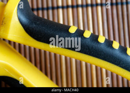 Pliers also known as pointy nose pliers or long nose pliers isolated on wooden background. Stock Photo