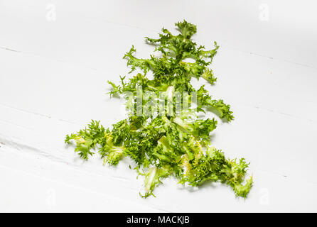 Christmas Food background. Christmas tree made from fresh frise on white background. Healthy holiday food, vegan, vegetarian and diet concept. Stock Photo