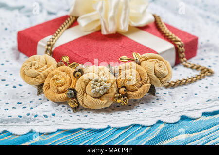 Handmade peach-colored necklace close up on the gift box background Stock Photo