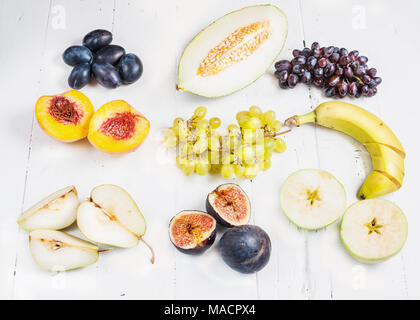 Colorful various of organic fruit on wooden rustic background top view. Stock Photo