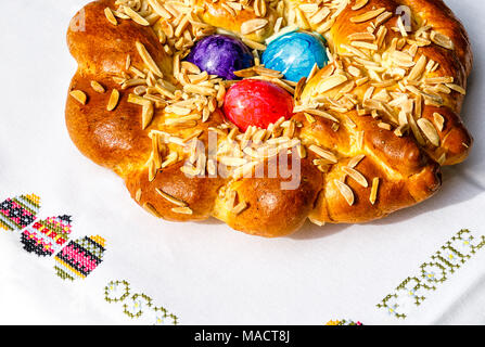 Homemade Easter traditional bread decorated with colorful eggs, festive bakery Stock Photo