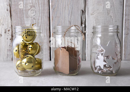 Christmas present wrapping supplies. Three mason jars with gift tags