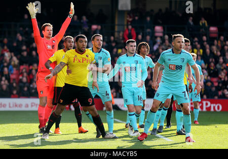 Watford's Troy Deeney (third left) and AFC Bournemouth's Dan Gosling (fourth left) jostle waiting for a free-kick to be taken during the Premier League match at Vicarage Road, London. PRESS ASSOCIATION Photo. Picture date: Saturday March 31, 2018. See PA story SOCCER Watford. Photo credit should read: Mark Kerton/PA Wire. RESTRICTIONS: EDITORIAL USE ONLY No use with unauthorised audio, video, data, fixture lists, club/league logos or 'live' services. Online in-match use limited to 75 images, no video emulation. No use in betting, games or single club/league/player publications. Stock Photo