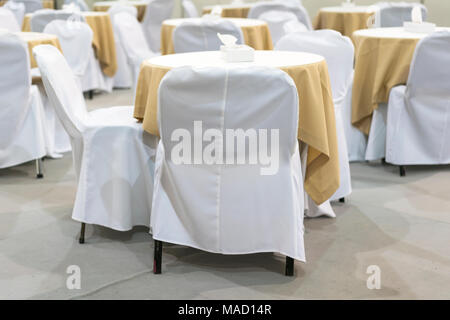 Empty tables in a cafe covered with white table. Stock Photo