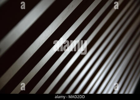 Some parallel lines creating a diagonal background. Low key backdrop. Stock Photo