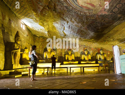 Tourists inside Dambulla Cave Temple, Dambulla, Sri Lanka, Asia. Stock Photo