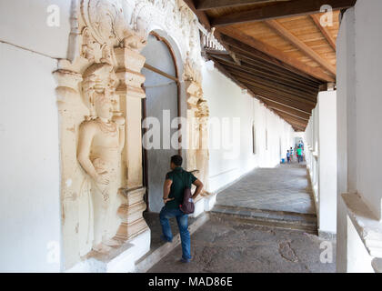 Man entering inside Dambulla Cave Temple, Dambulla, Sri Lanka, Asia. Stock Photo