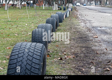 Car tire in a row in public park, background, Tyre truck texture closeup Stock Photo