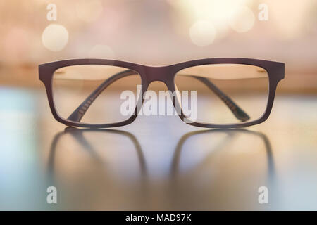 Pastel eye glasses on wood background with bokeh. Stock Photo
