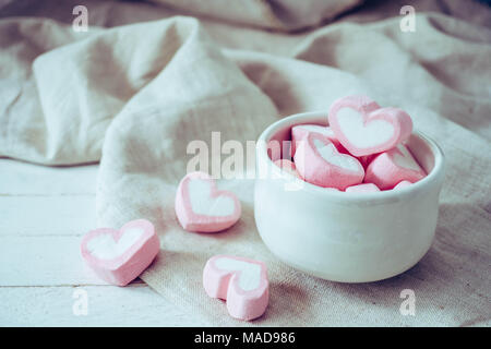 Heart shape marshmallows in white mug on wood background, sweet and  love concept Stock Photo