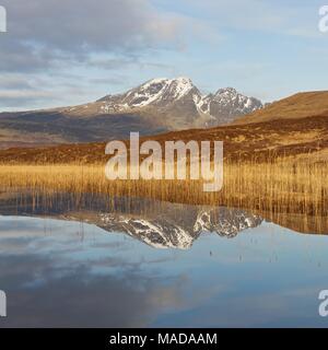 Blaven and reflections in Loch Cill Chriosd taken on a cool crisp springs morning. The sunrise was colourful Stock Photo