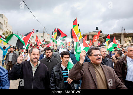 Bilin, Palestine, January 1, 2011: Protesters march during a demonstration against Israeli presence in West Bank. Stock Photo