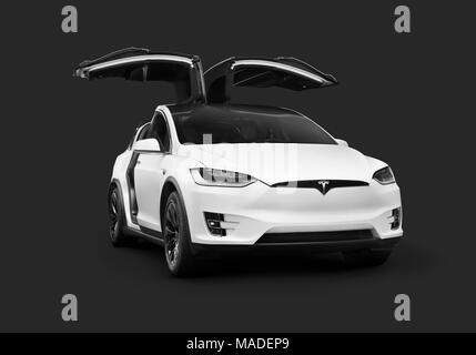 License and prints at MaximImages.com - White 2018 Tesla Model X luxury SUV electric car with open falcon wing doors isolated on dark gray black Stock Photo