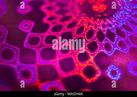 Close-up part of defocused fantastic round multicolored pattern of textured holographic paper. Soft focus. Stock Photo