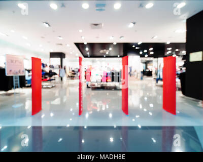 Shopping mall blur background with bokeh. Abstract blurred entrance area of clothes and shoes store. Copy space Stock Photo