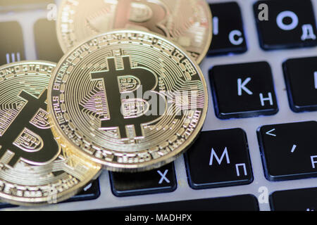 Bitcoin on keyboard against background with blurry graph Stock Photo ...
