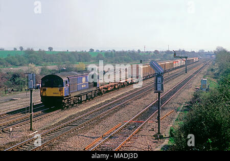 A class 58 diesel locomotive number 58026 with a train of Bardon stone ...