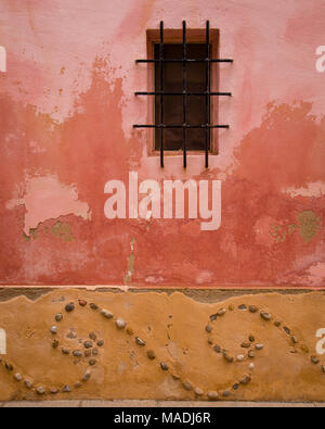 Window and wall with stone patterns and flaking paint, Sant Elm, Mallorca Stock Photo