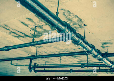 Old water pipes under  roof Stock Photo