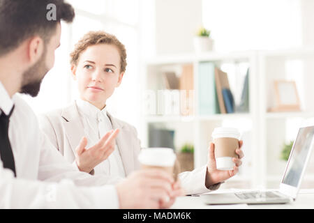 Two coworkers planning work and drinking coffee Stock Photo
