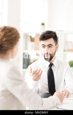 Young businessman talking with his female colleague at office Stock Photo
