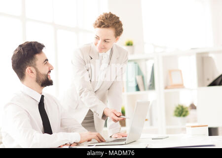 Businesswoman explaining to her partner presentation on computer Stock Photo