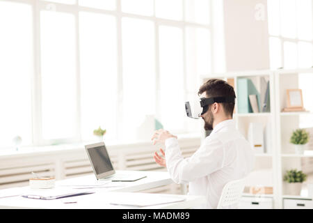 Businessman using virtual reality device in the office Stock Photo