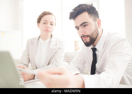 Business people working at the table together and using laptop Stock Photo