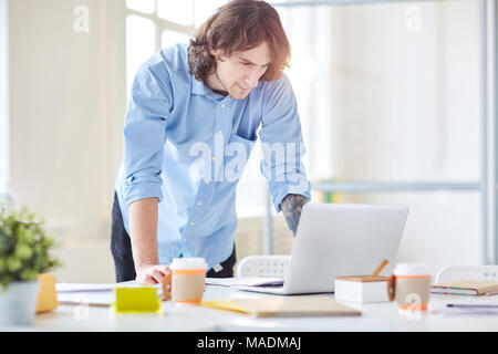 Businessman using laptop at office. He is making presentation Stock Photo