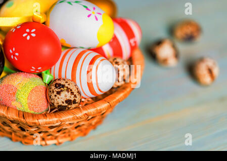Several colorful Easter eggs in basket close Stock Photo