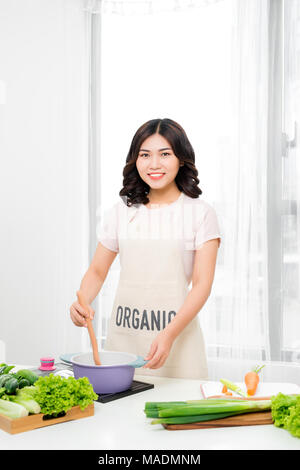 Young Woman Cooking in the kitchen. Healthy Food. Dieting Concept. Healthy Lifestyle. Cooking At Home. Prepare Food Stock Photo