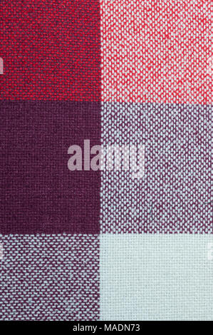 Textured with a pattern of squares of shades of red and purple Stock Photo