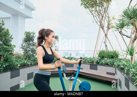 Woman Exercising At Outdoors Gym Playground Equipment Stock Photo