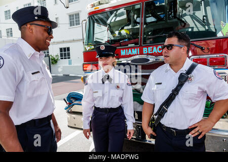 Miami Beach Florida,Veterans Day,parade staging area,Miami Beach,Fire Department,firefighter,formal uniform,ax,Hispanic,immigrant immigrants,Black Afr Stock Photo