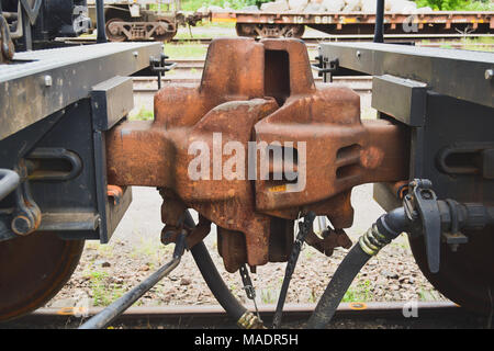 Close-up of coupling between two railway cars on tracks Stock Photo