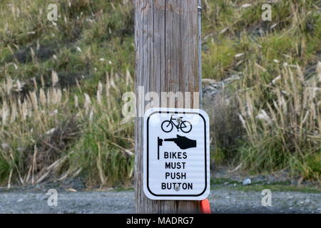 Push button road crossing sign for cyclists. Stock Photo