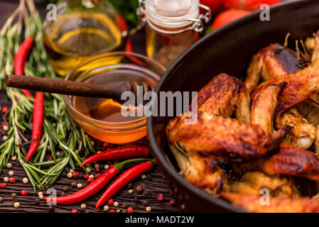 Baked chickens wings covered in honey, vegetables Stock Photo
